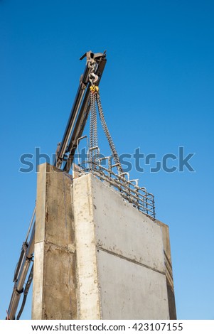 Crane removing formwork encasement from a f