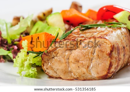 grilled pork meat and vegetables on white plate with mustard sau