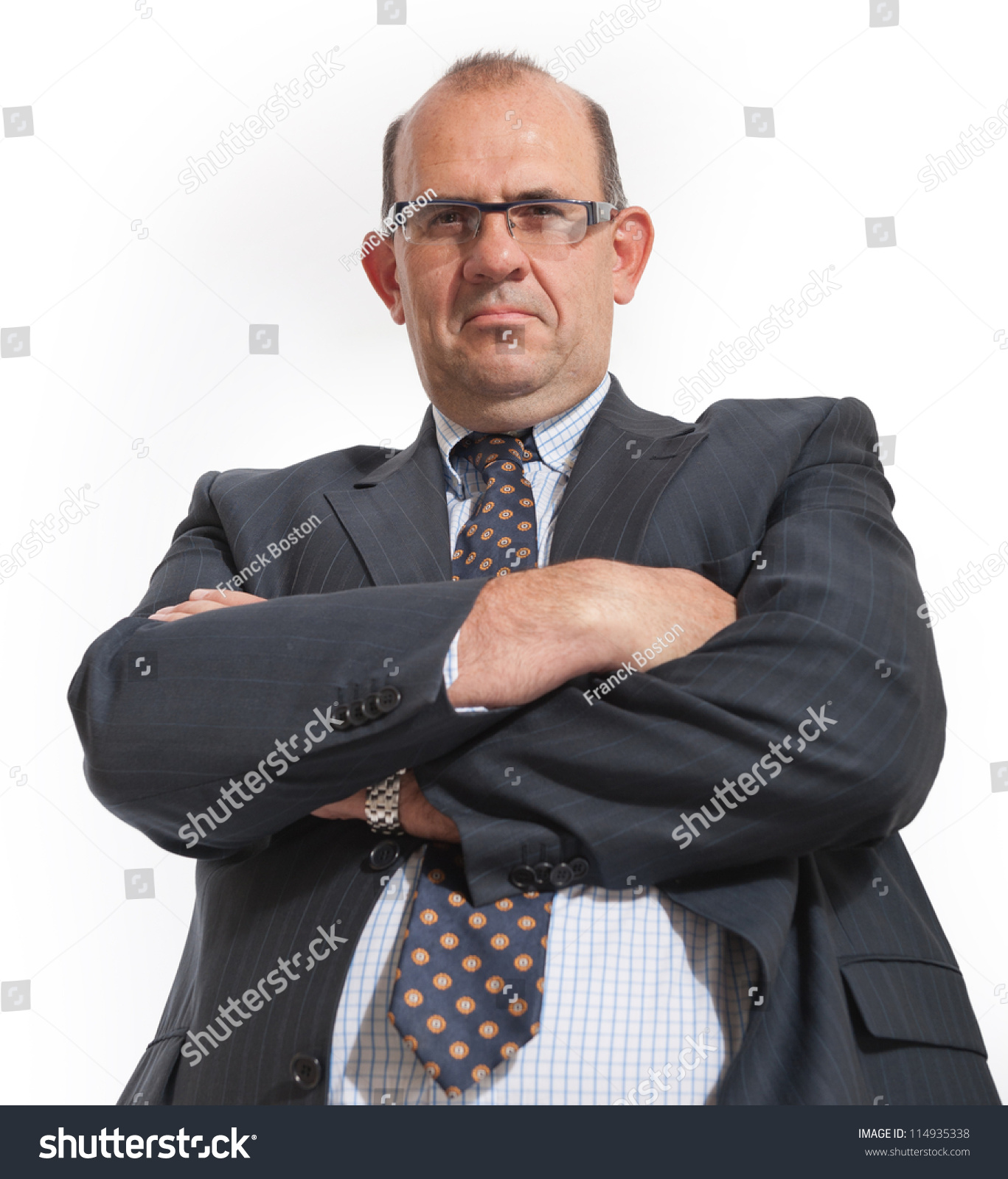 imposing man in business attire with arms crossed