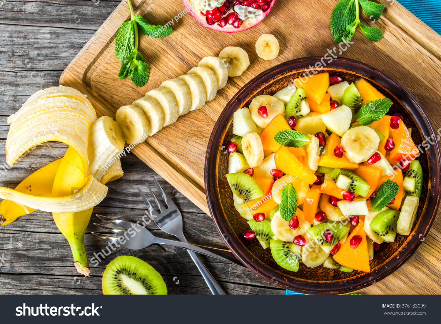 delicious fruit salad in a clay brown dish on a cutting board