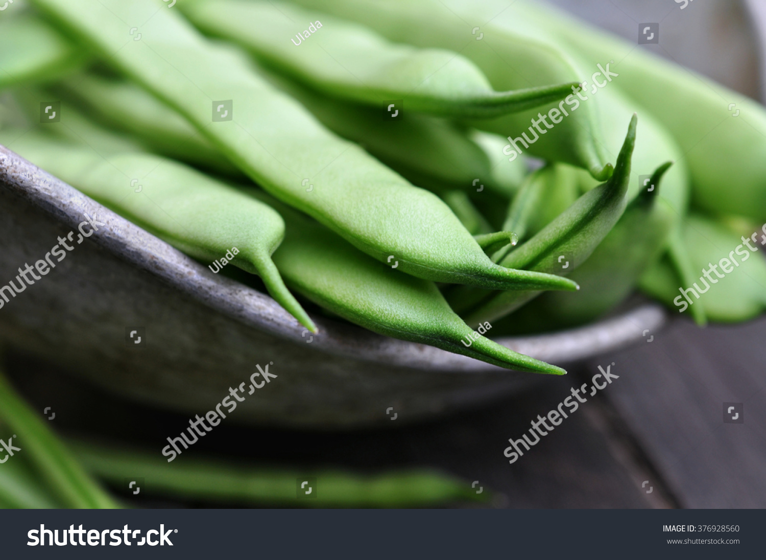 fresh raw harvested green beans in rustic colander, selective